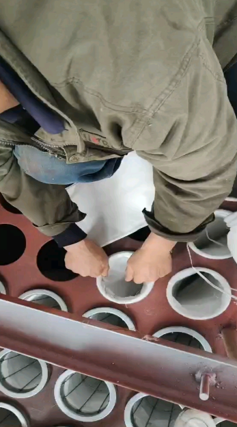 技术人员正在使用水平仪检查布袋除尘器花板的水平度